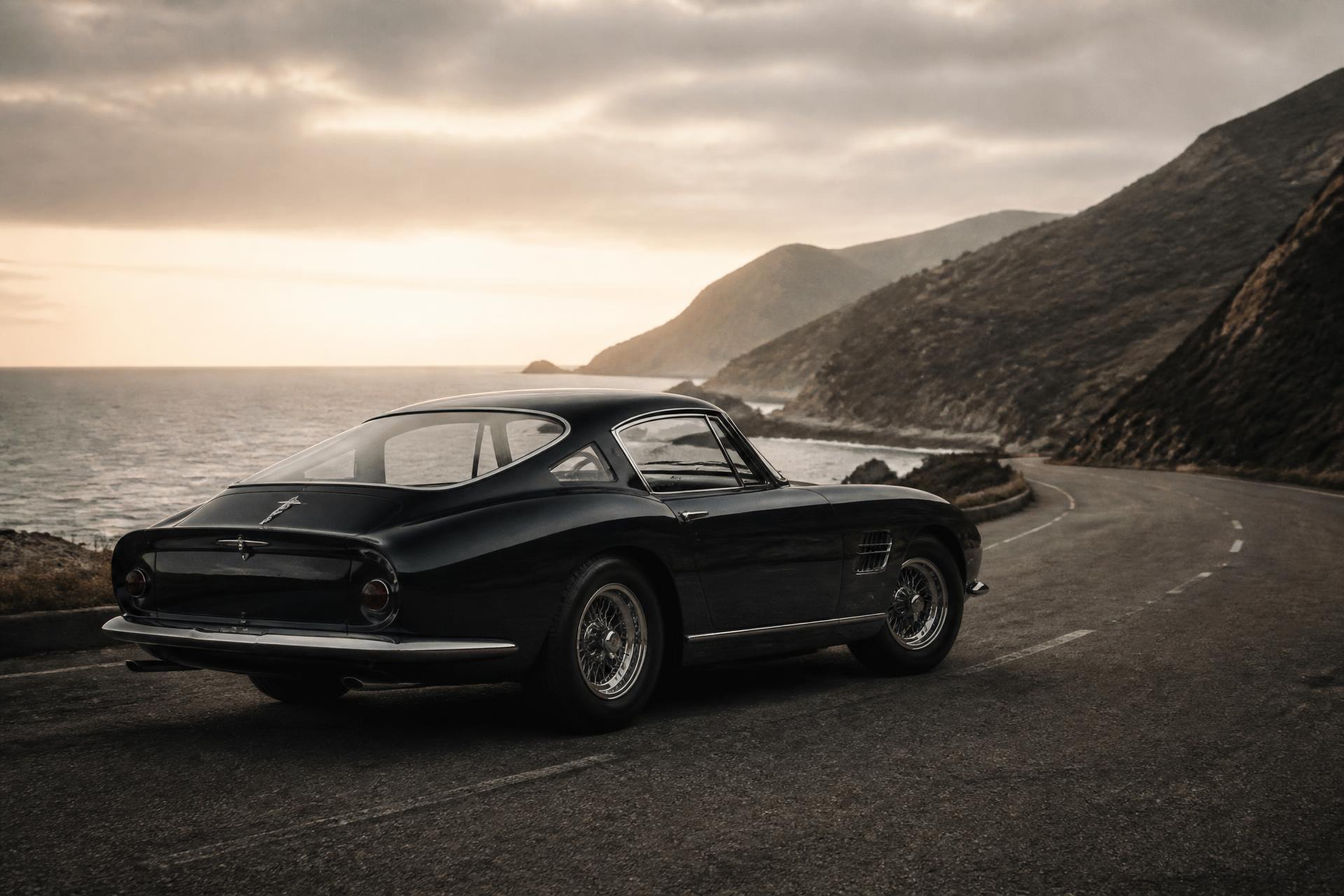 Classic sports car on an empty coastal road at first light