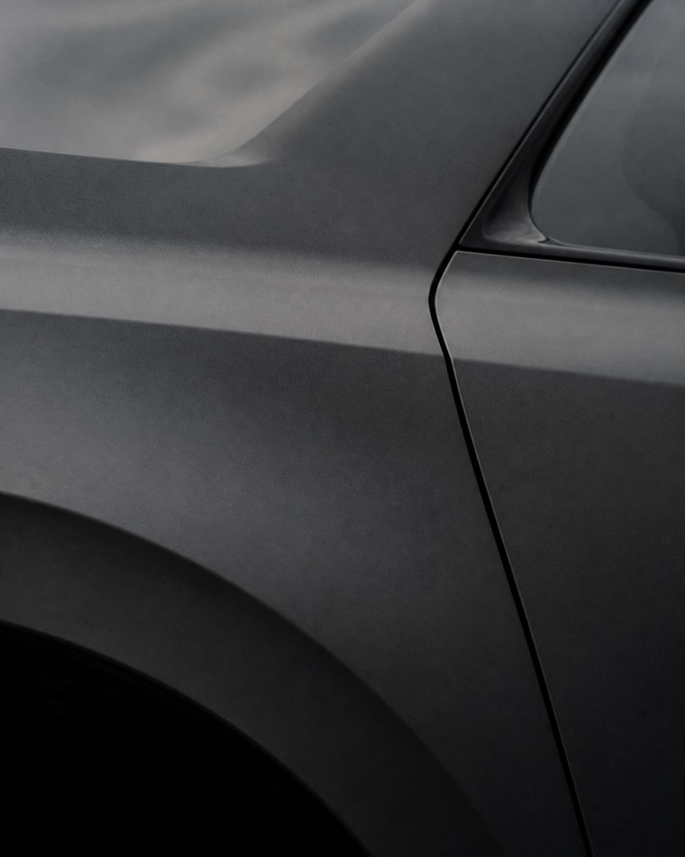 Abstract crop of a matte grey car body panel